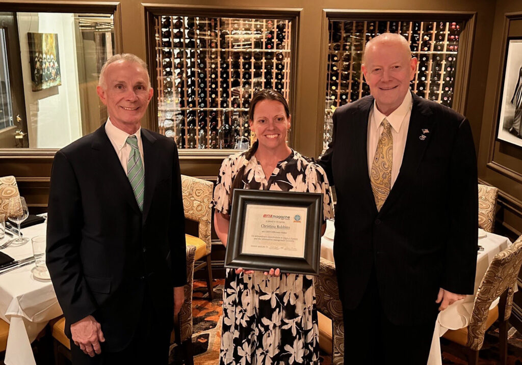 Christina Robbins holding an award standing next to HK Bain, CEO of Digitech Systems 