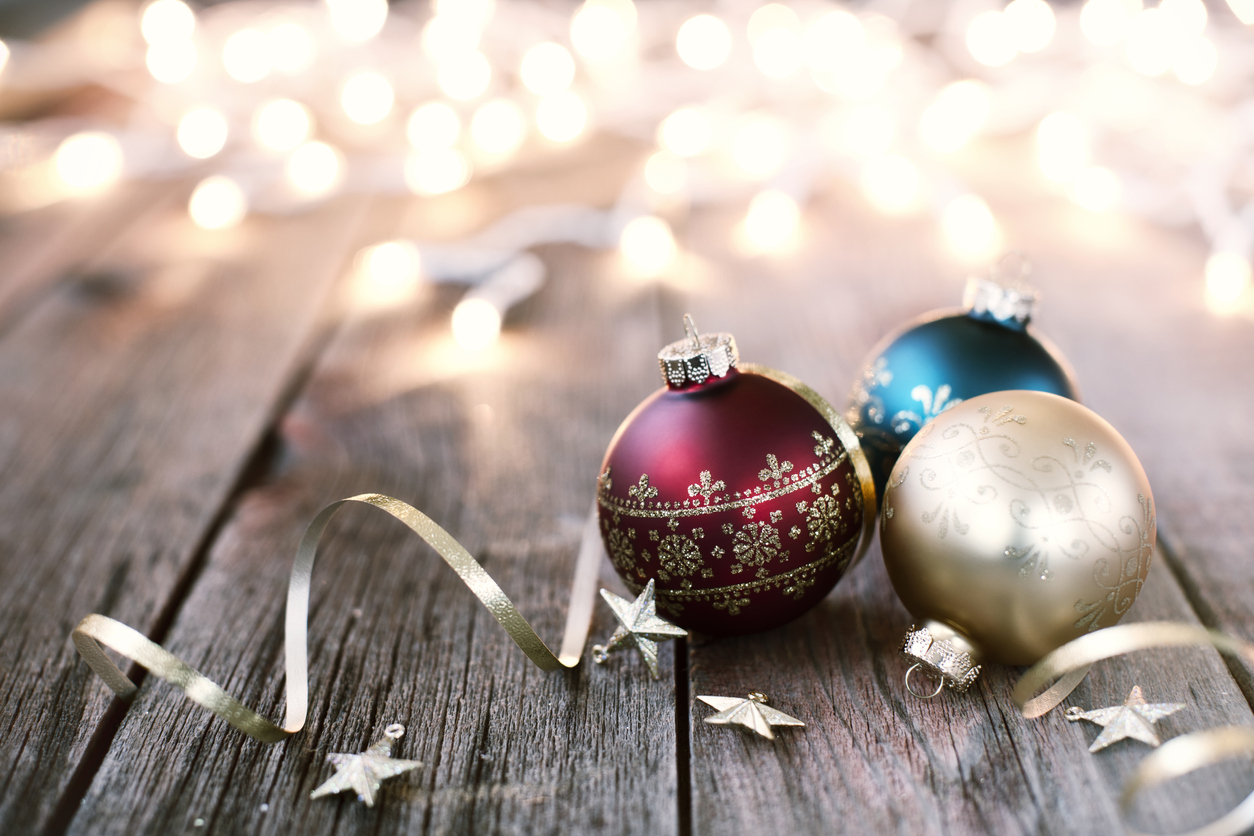 Christmas Baubles with Ribbon and Stars on Old Wood Background