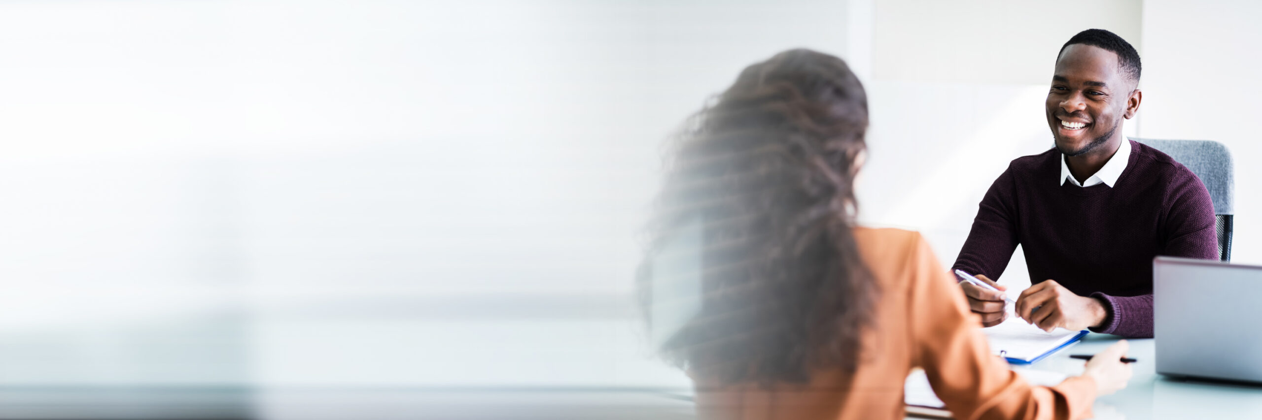 Two Businesspeople Talking With Each Other At Office