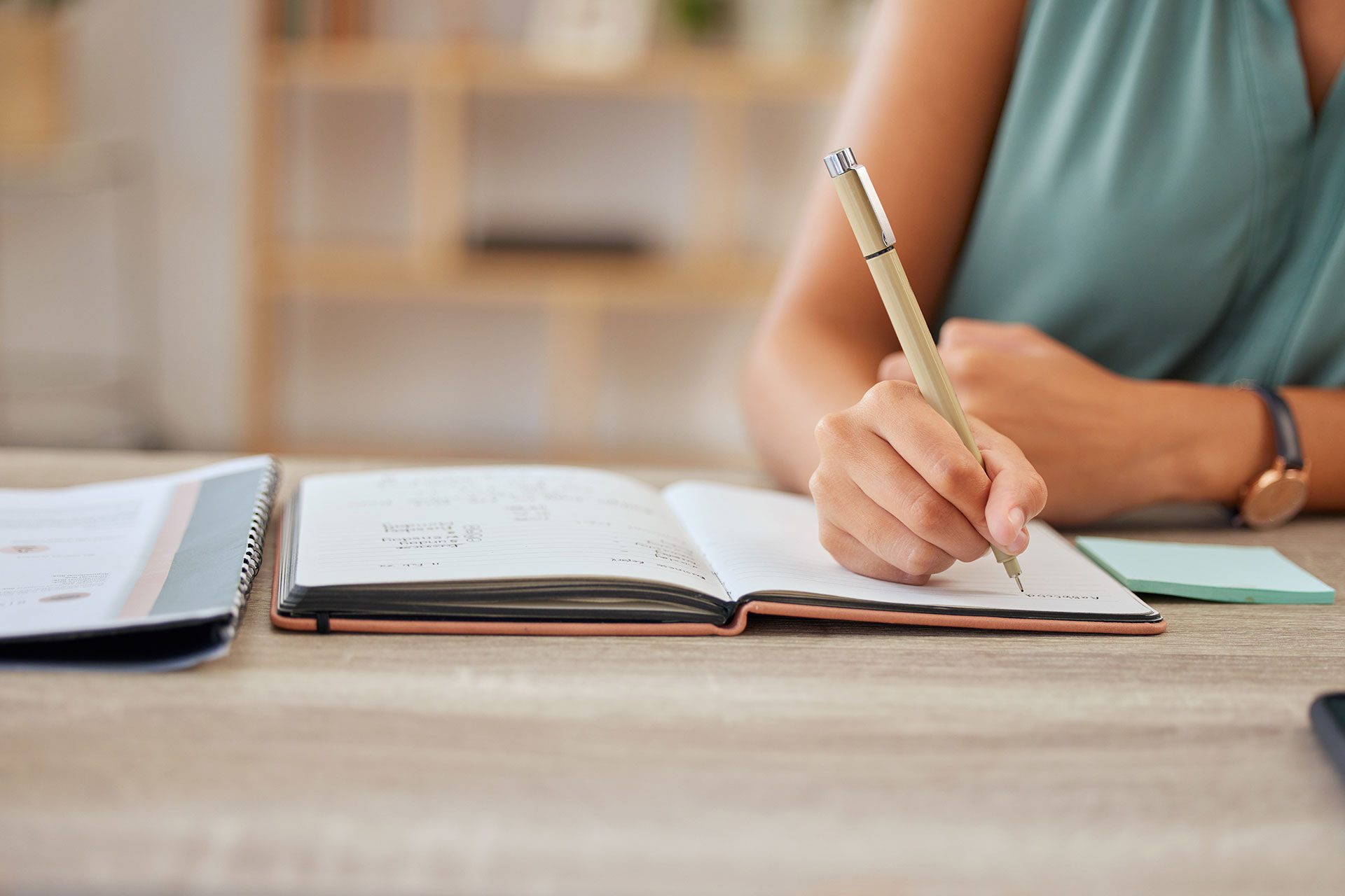 person writing in notebook